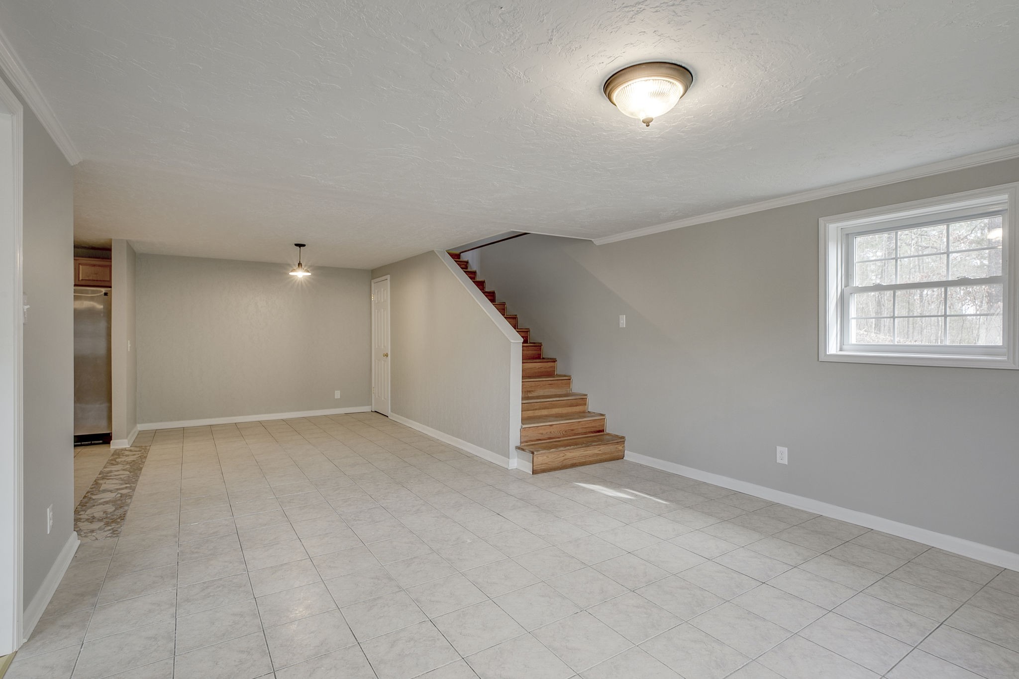 335 Eva Harbor Road Eva, TN 38333 - Photo 9 of 32 an empty room with windows and stairs