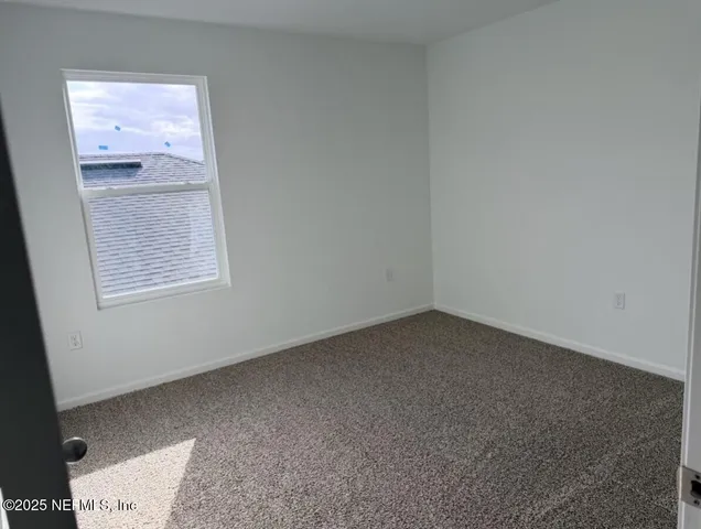 a sign of golf club on a wall under a large tree