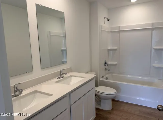 an aerial view of a house with swimming pool and patio