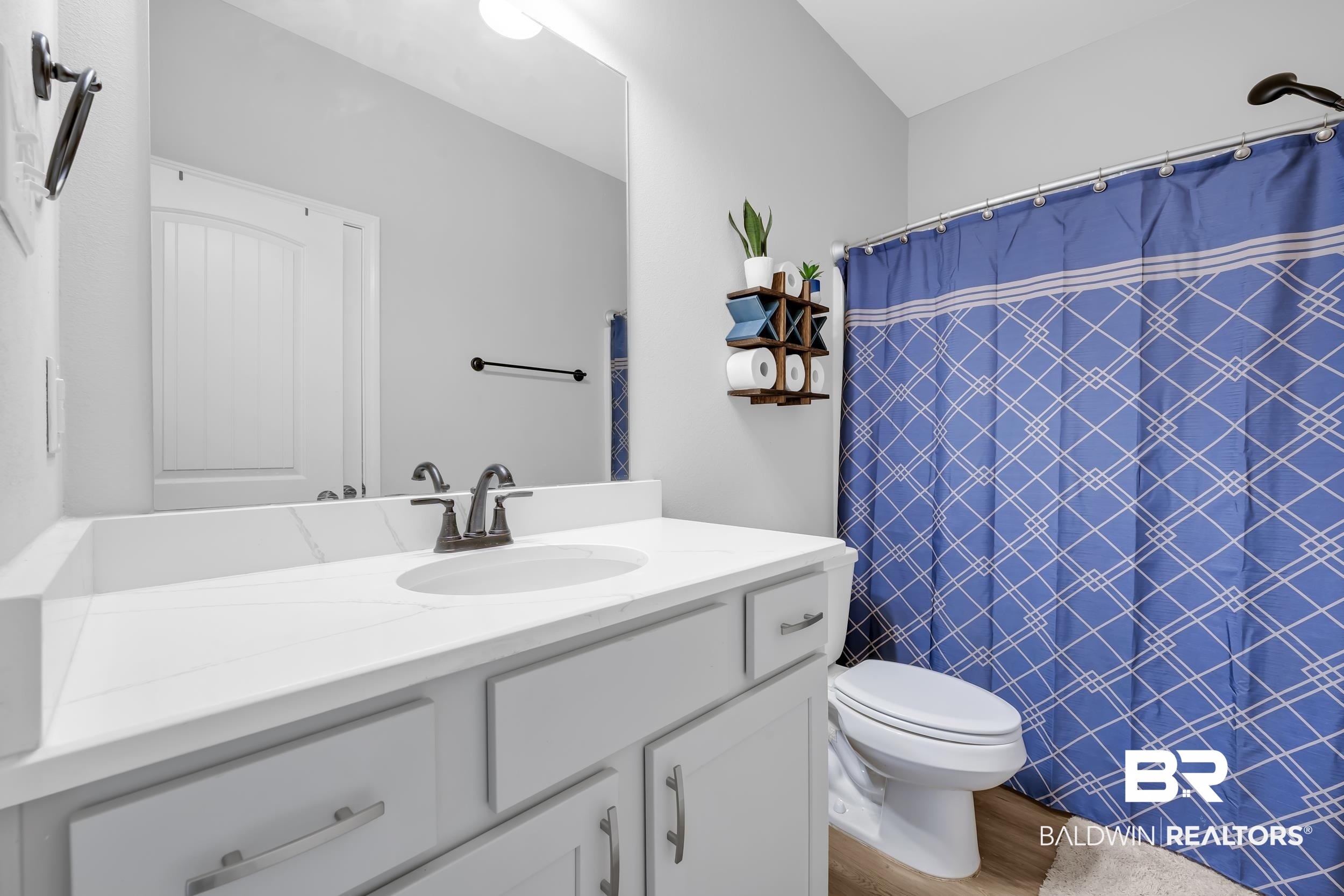 1176 Stella Road Foley, AL 36535 - Photo 26 of 40 Bathroom with vanity, a shower with shower curtain, and wood finished floors