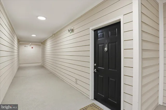 a view of a hallway with couch and closet