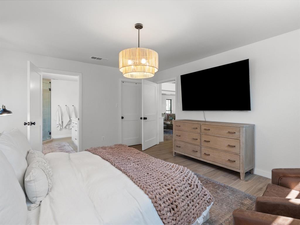 946 Burke Road Gunter, TX 75058 - Photo 15 of 38 Primary Bedroom featuring light wood flooring and ensuite bathroom