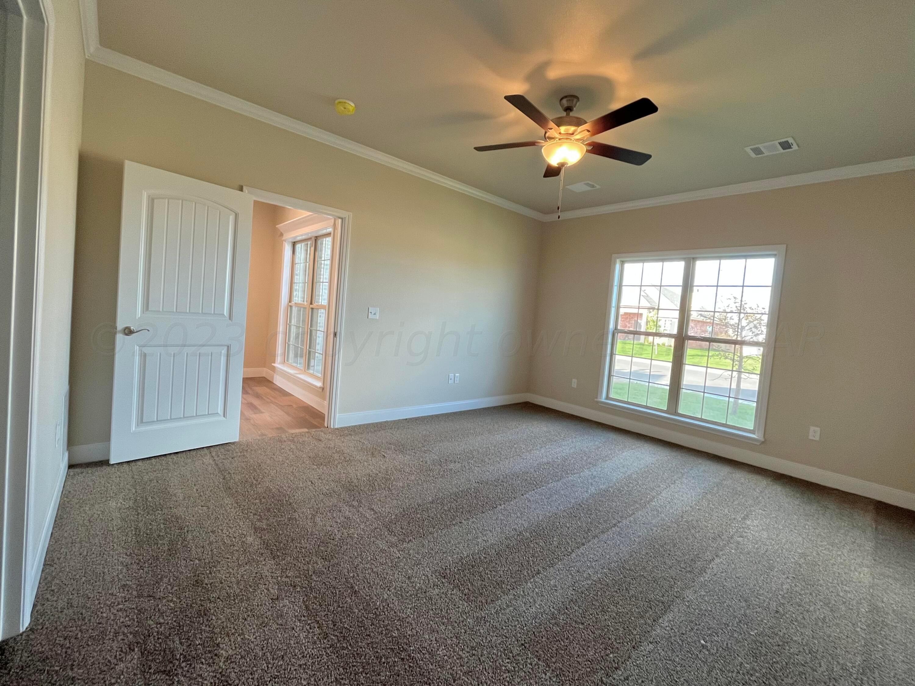 7610 Crestline Drive Amarillo, TX 79119 - Photo 4 of 9 a view of a livingroom with a ceiling fan and window