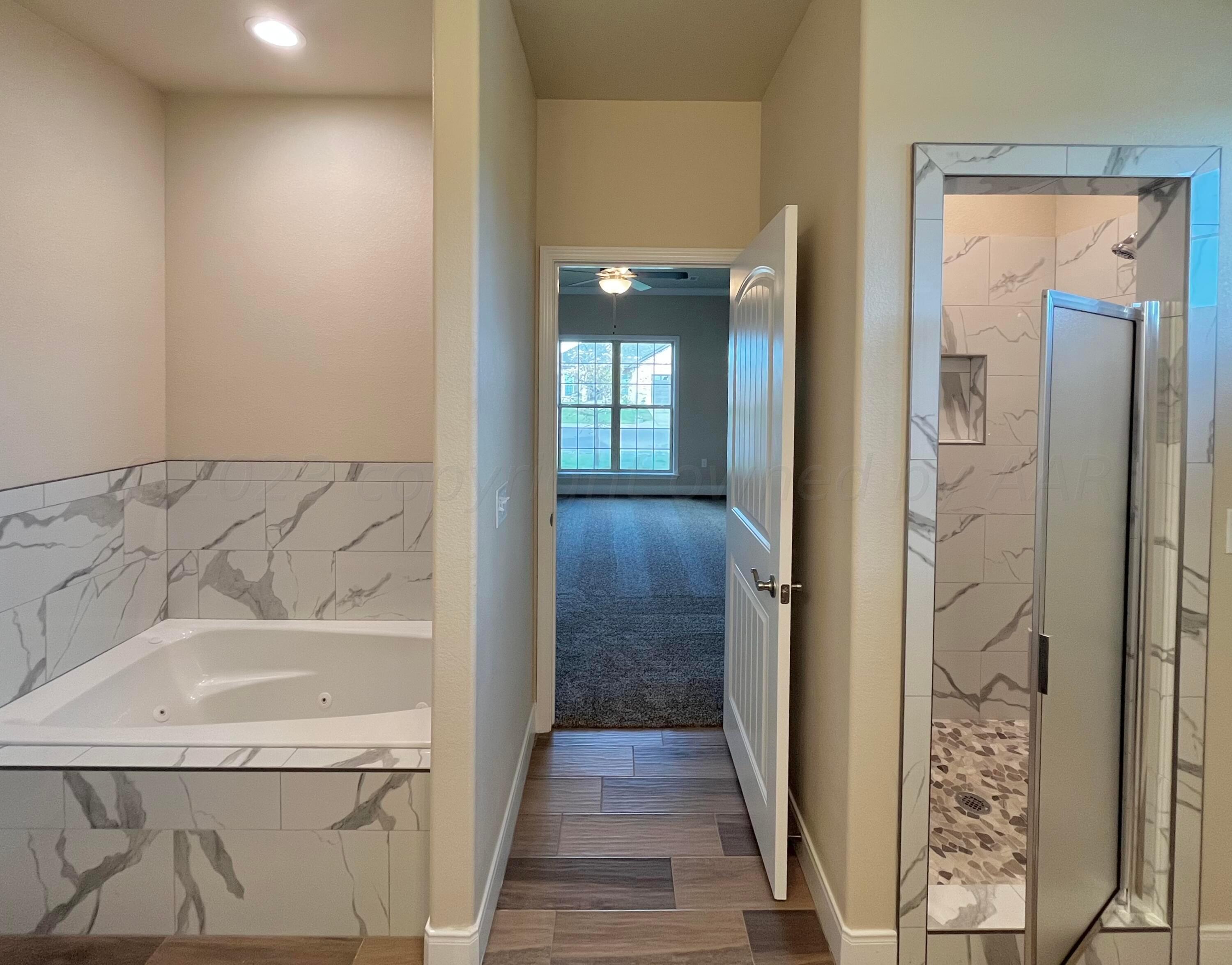 7610 Crestline Drive Amarillo, TX 79119 - Photo 6 of 9 a bathroom with a bathtub and shower