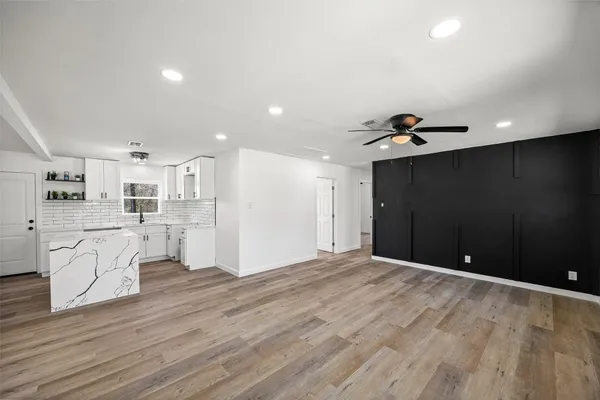 a front view of a house with a garden and yard