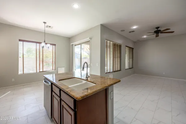 a bathroom with a granite countertop sink and mirror