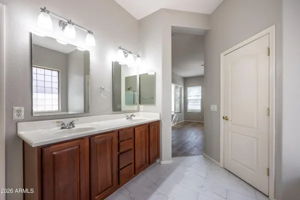 a bathroom with a double vanity sink and a mirror