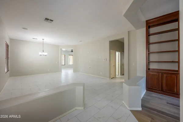a view of an empty room with a fireplace and cabinet