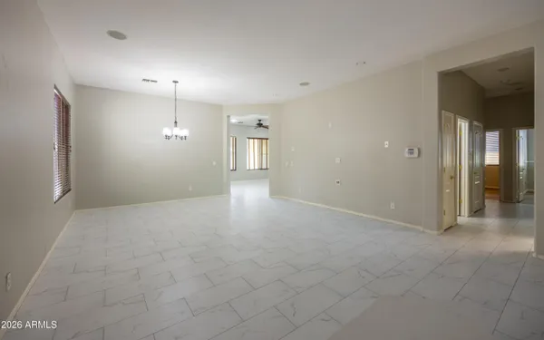 an empty room with fan and entrance