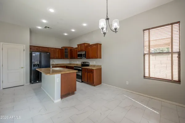 a kitchen with stainless steel appliances granite countertop a stove and a refrigerator