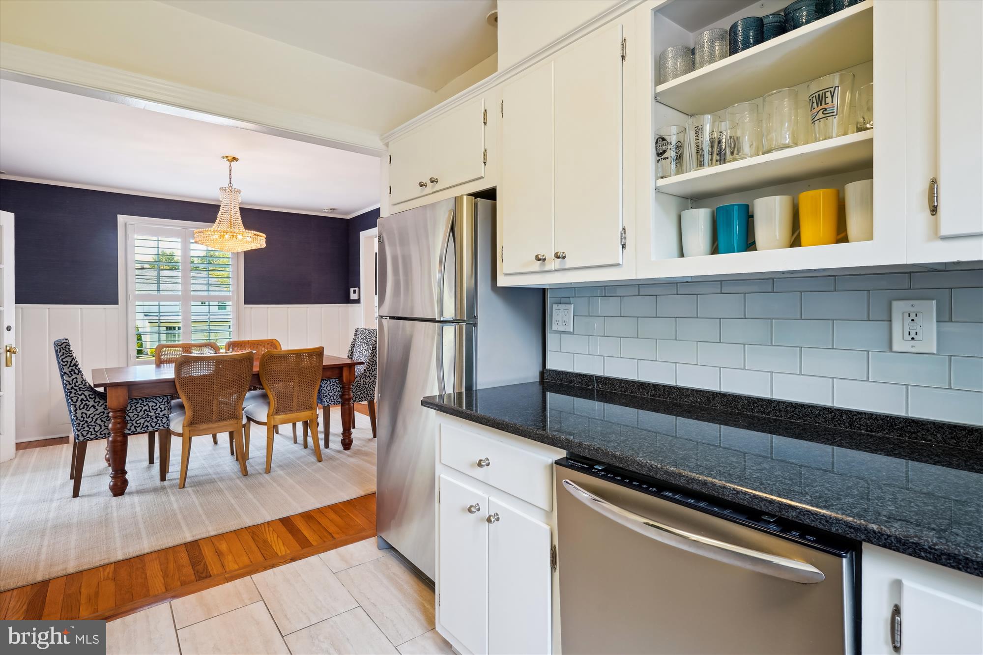 4317 Saul Road Kensington, MD 20895 - Photo 13 of 33 a kitchen with stainless steel appliances granite countertop a stove a refrigerator a dining table and chairs