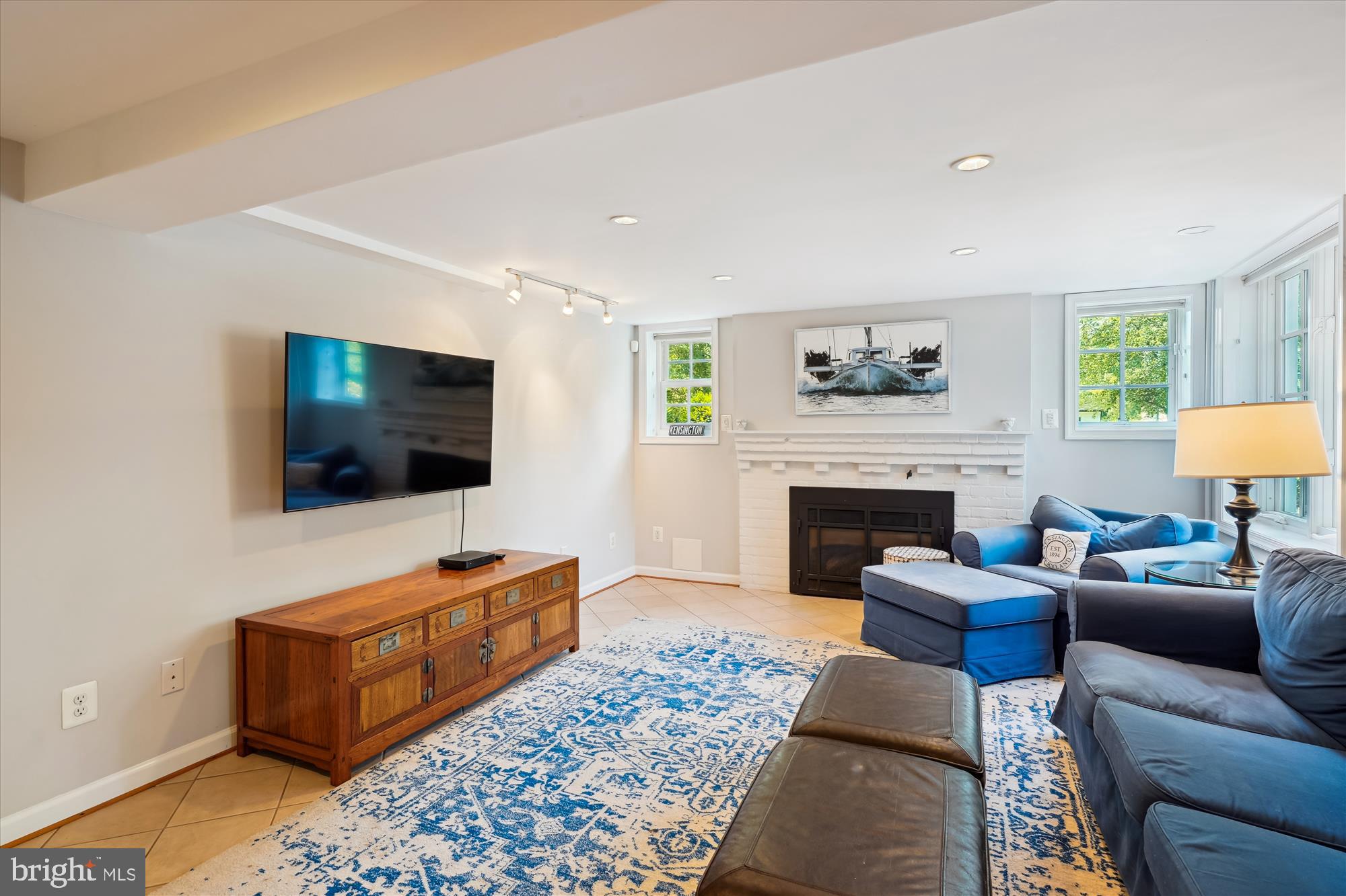 4317 Saul Road Kensington, MD 20895 - Photo 26 of 33 a living room with furniture a flat screen tv and a fireplace