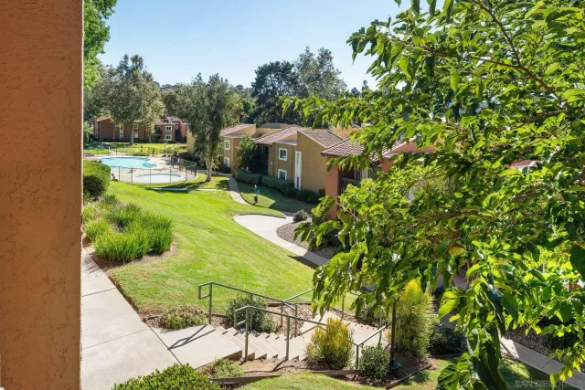a kitchen with granite countertop a sink cabinets stainless steel appliances and a counter top space