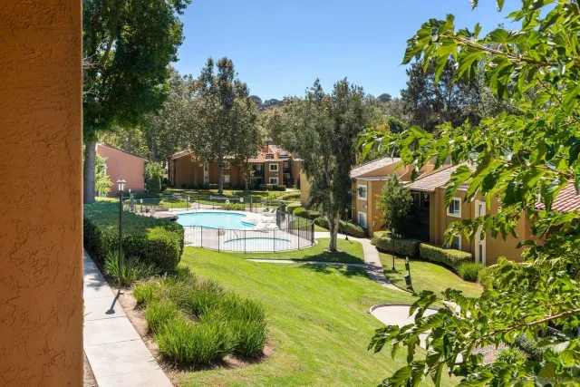 a kitchen with granite countertop a stove a sink and a refrigerator