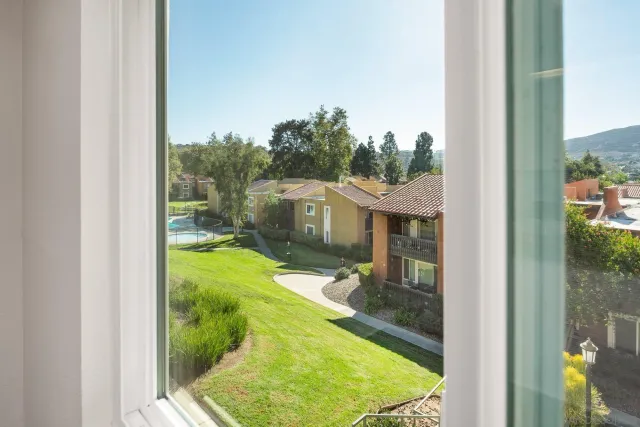 a kitchen with granite countertop white cabinets appliances and a sink