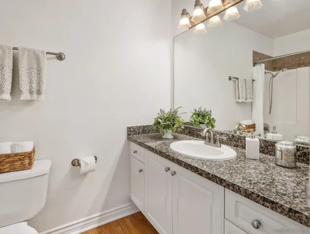 a white house with a small yard and large trees