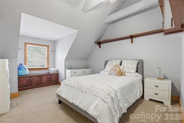 a bed room with a bed and a chair