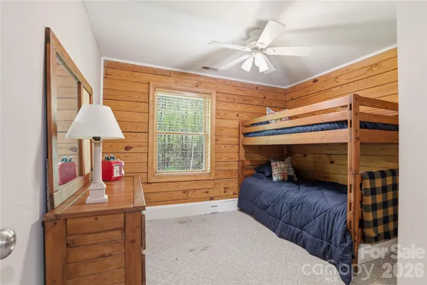 a bedroom with bed and a chandelier