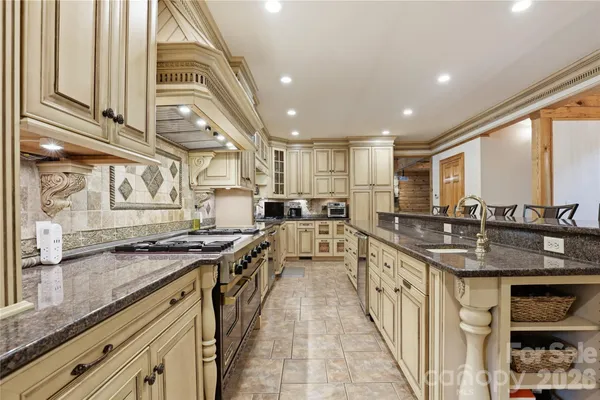 a kitchen with stainless steel appliances granite countertop a sink and stove