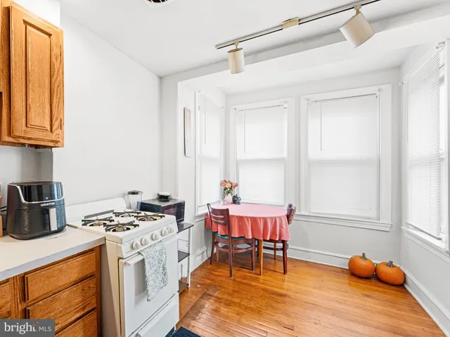 a kitchen with stainless steel appliances kitchen island granite countertop a stove a sink and a microwave