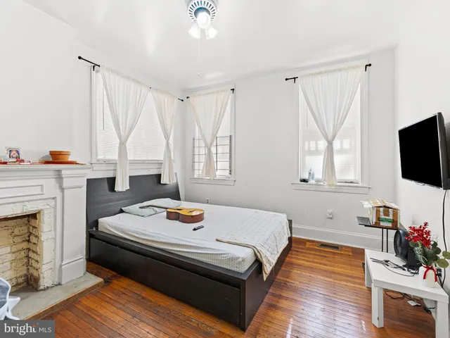 a bedroom with a bed and flat screen tv