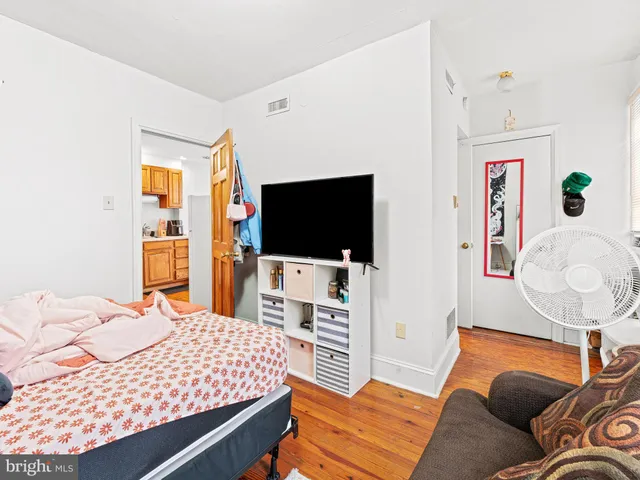 a bedroom with a bed and a flat screen tv