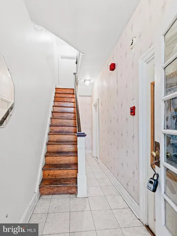 a view of entryway with stairs and white walls