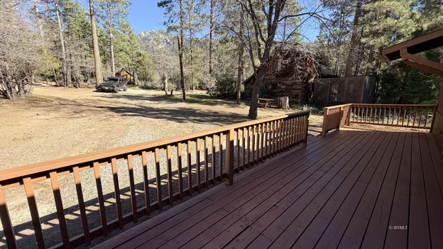 a view of a wooden deck with a yard