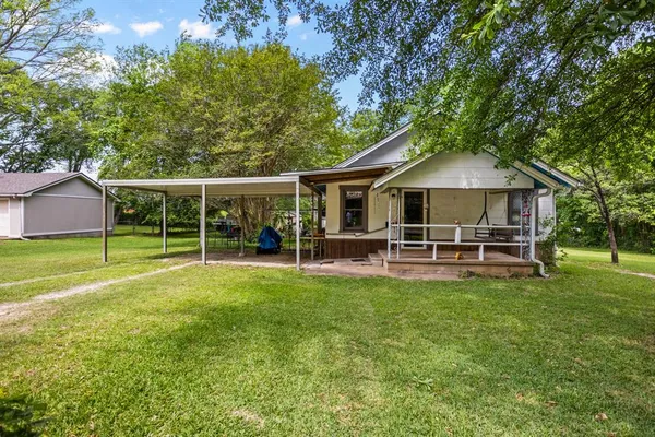 a view of a house with a yard porch and sitting area