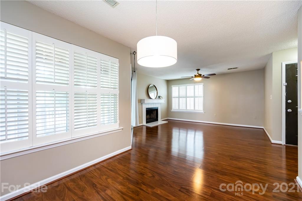 5003 Sharon Road, Unit G Charlotte, NC 28210 - Photo 11 of 42 an empty room with wooden floor and windows
