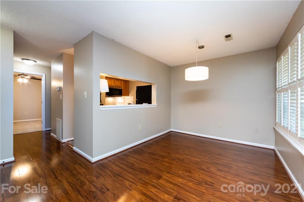 5003 Sharon Road, Unit G Charlotte, NC 28210 - Photo 12 of 42 a view of a big room with wooden floor and windows