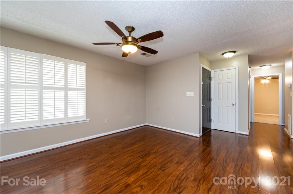 5003 Sharon Road, Unit G Charlotte, NC 28210 - Photo 15 of 42 a view of an empty room with wooden floor and a window