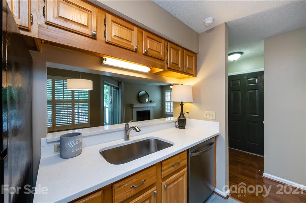5003 Sharon Road, Unit G Charlotte, NC 28210 - Photo 19 of 42 a kitchen with a sink and a refrigerator