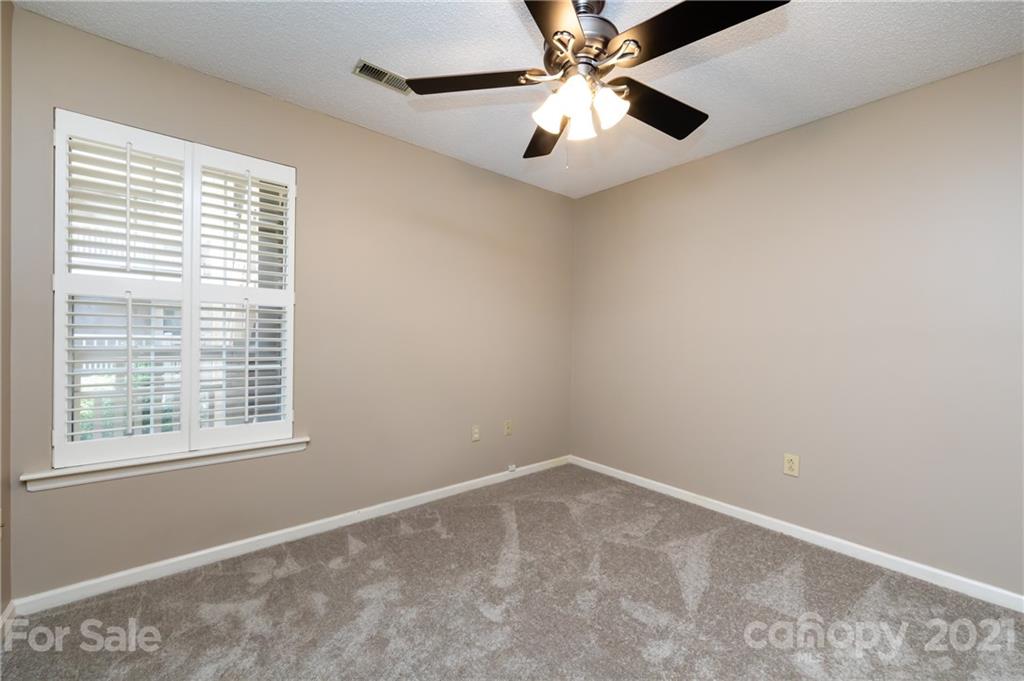 5003 Sharon Road, Unit G Charlotte, NC 28210 - Photo 21 of 42 an empty room with a window and a fan
