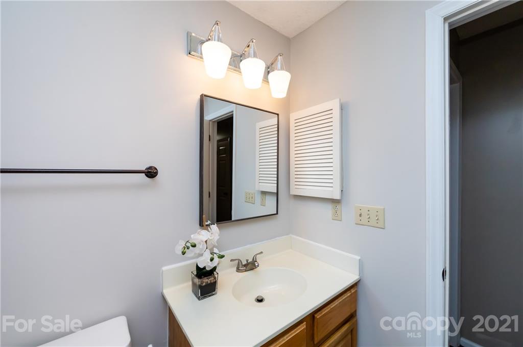 5003 Sharon Road, Unit G Charlotte, NC 28210 - Photo 23 of 42 a bathroom with a sink and a mirror
