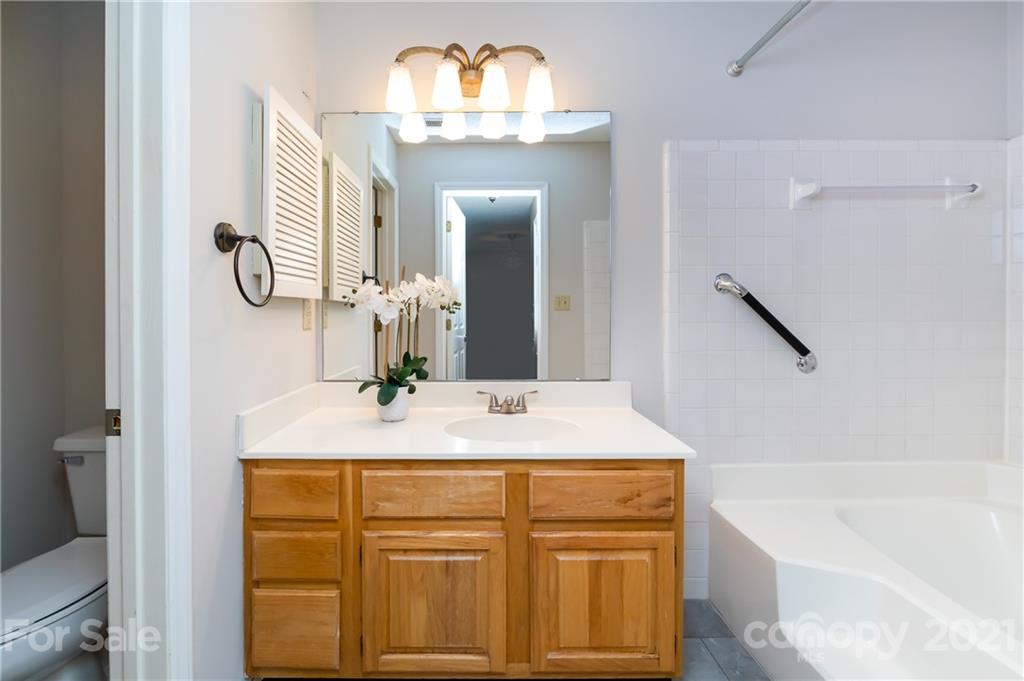 5003 Sharon Road, Unit G Charlotte, NC 28210 - Photo 33 of 42 a bathroom with a sink and a mirror