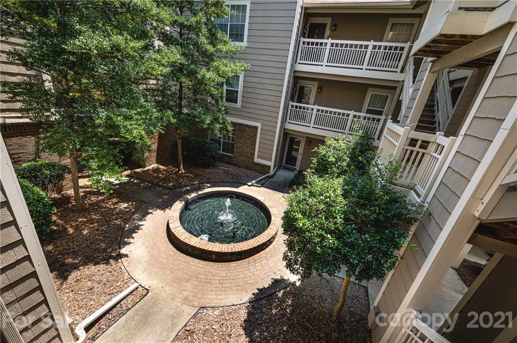 5003 Sharon Road, Unit G Charlotte, NC 28210 - Photo 4 of 42 a backyard of a house with wooden floor and outdoor seating