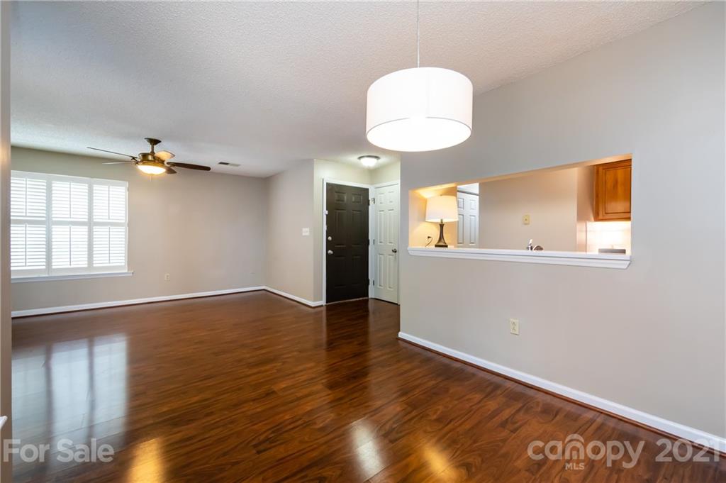 5003 Sharon Road, Unit G Charlotte, NC 28210 - Photo 10 of 42 a view of an empty room with wooden floor and a window
