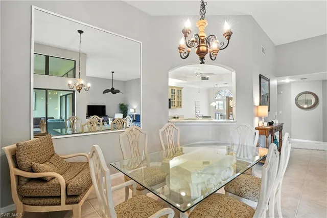 a living room with fireplace furniture and a chandelier