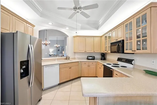 a kitchen with granite countertop a refrigerator oven a sink a stove and cabinets