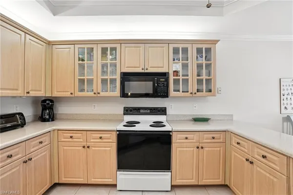 a kitchen with stainless steel appliances white cabinets and a stove top oven