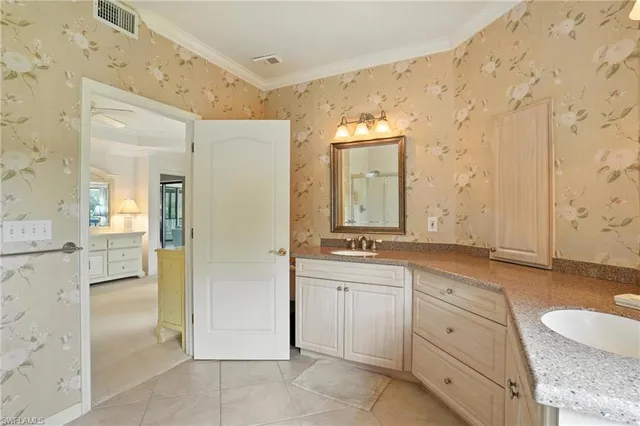 a bathroom with a granite countertop sink mirror and