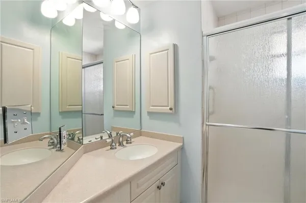 a bathroom with a double vanity sink mirror and double