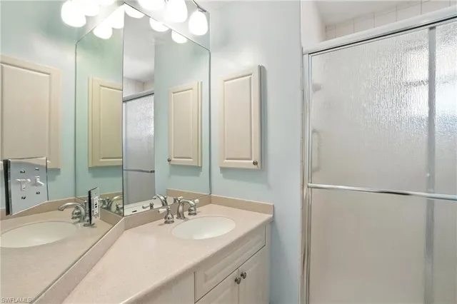a bathroom with a double vanity sink mirror and double