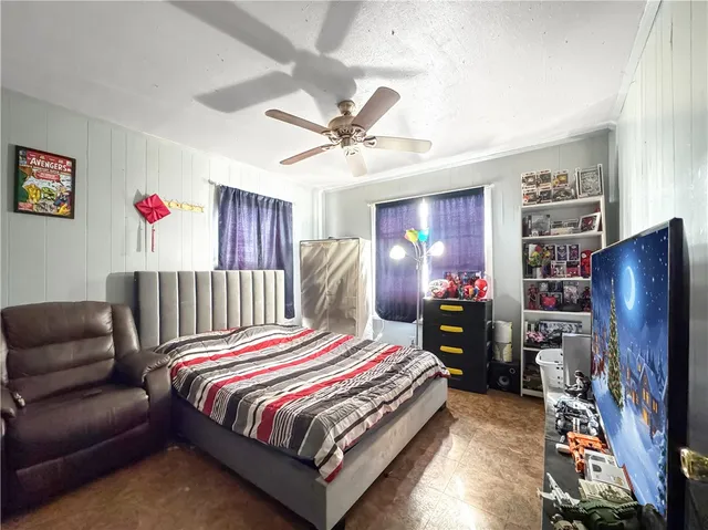 a bedroom with a bed closet and a flat tv screen