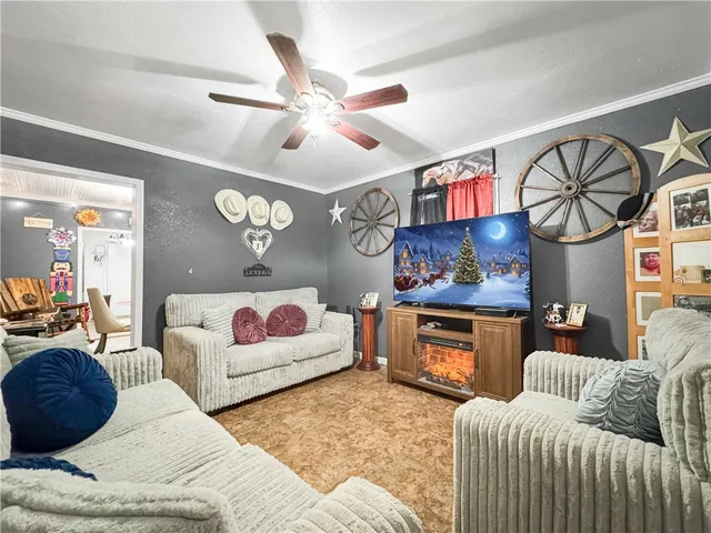 a living room with furniture fireplace and flat screen tv