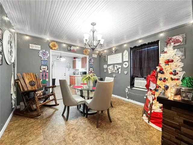 a dining room with furniture and a chandelier