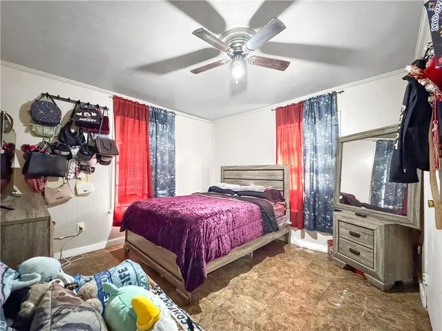 a bedroom with a bed dresser and a window