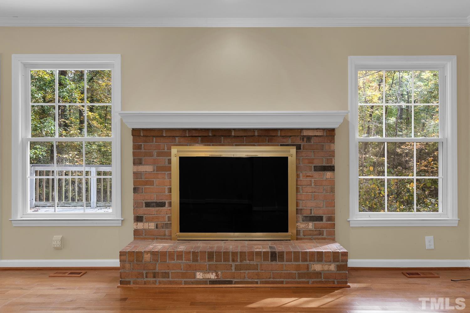 5908 Scalybark Road Durham, NC 27712 - Photo 12 of 30 a living room with a fireplace and a window