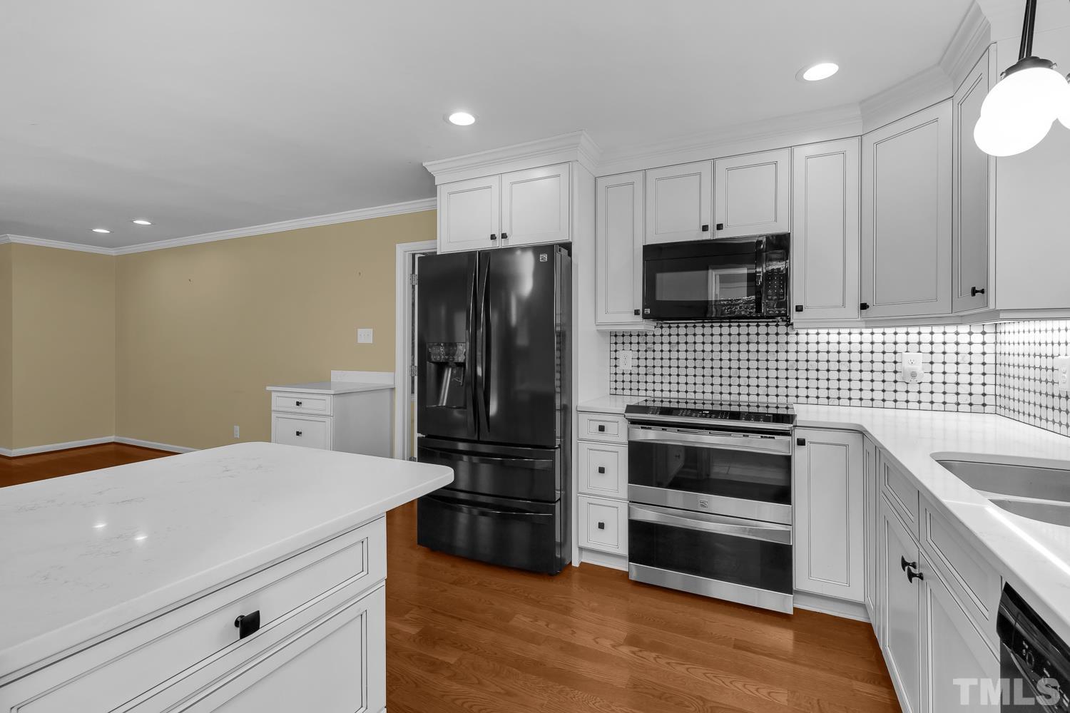 5908 Scalybark Road Durham, NC 27712 - Photo 19 of 30 a kitchen with stainless steel appliances a refrigerator sink and microwave